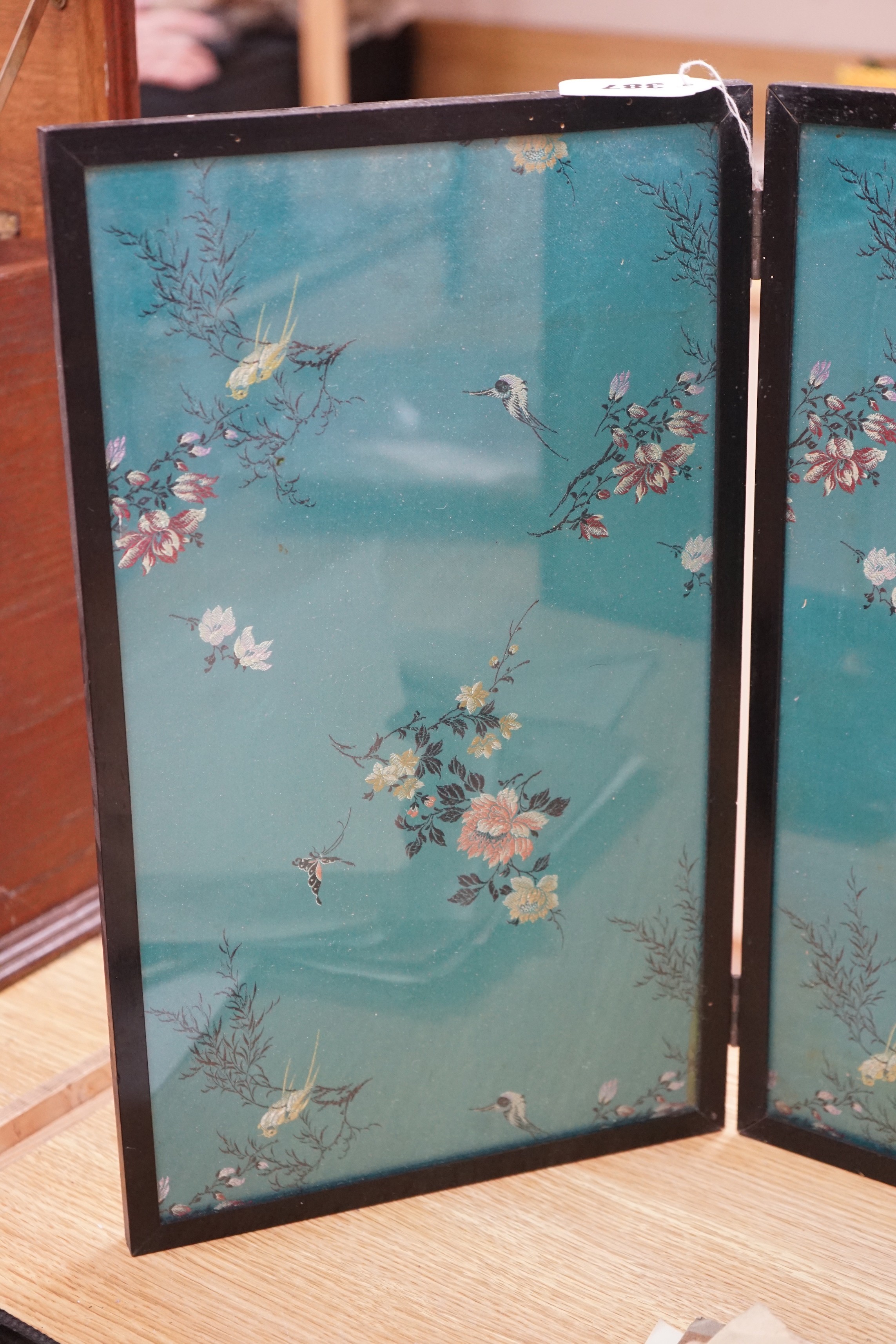 A Chinese embroidered silk inset three fold screen, largest panel 40 x 47cm